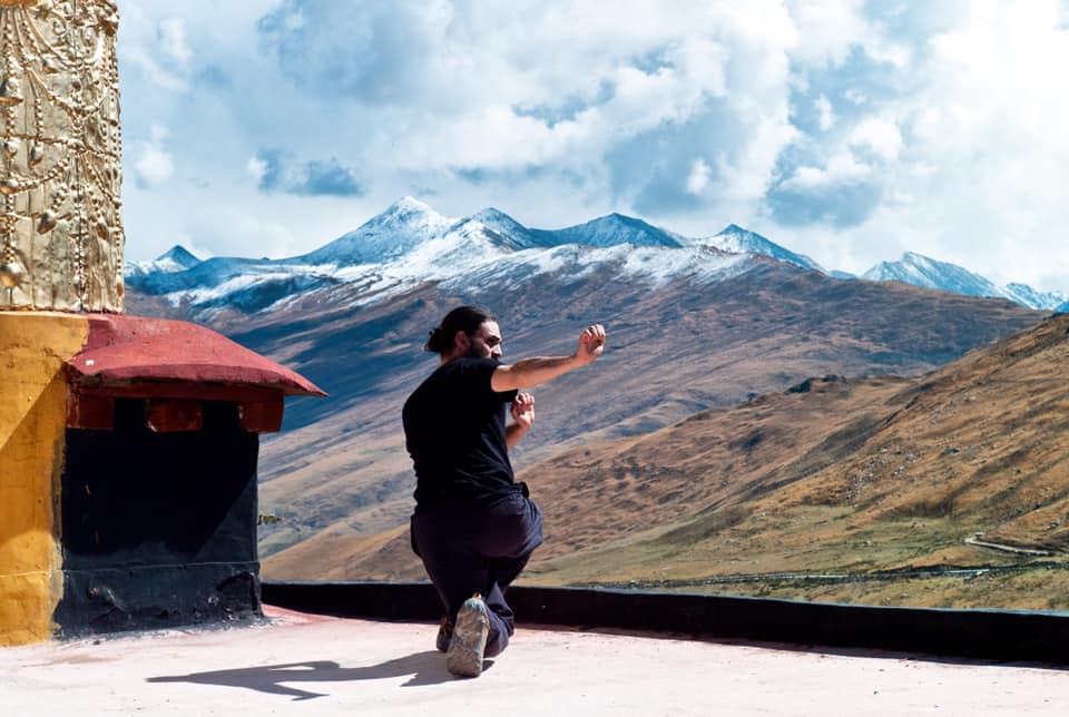 man doing martial arts outside